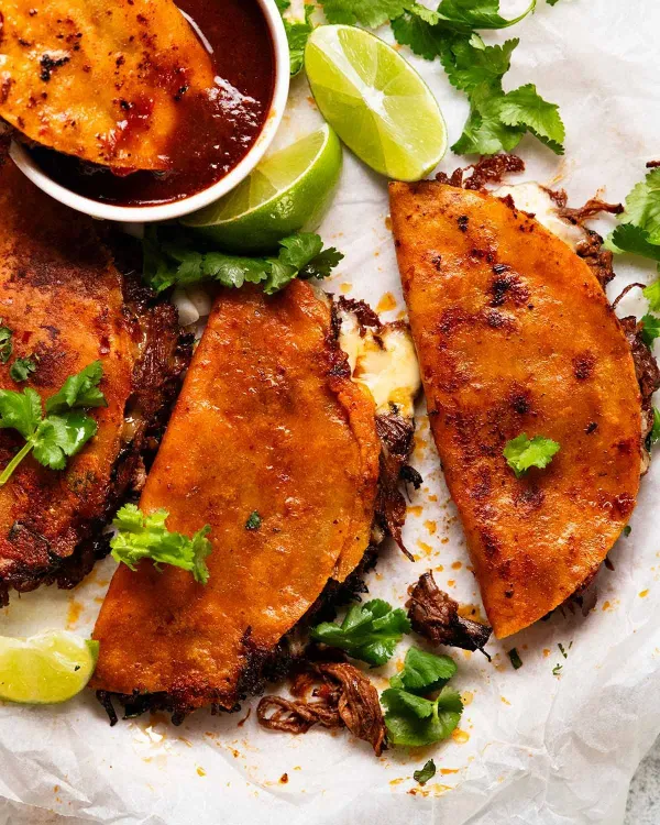 Birria tacos with consomme dipping sauce